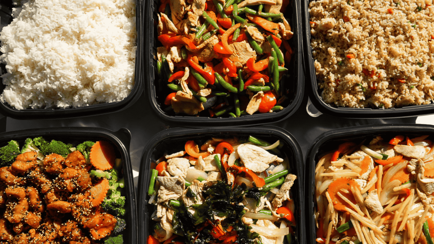 Bangkok Thai catering trays with rice, noodles, vegetables, and Thai entrees