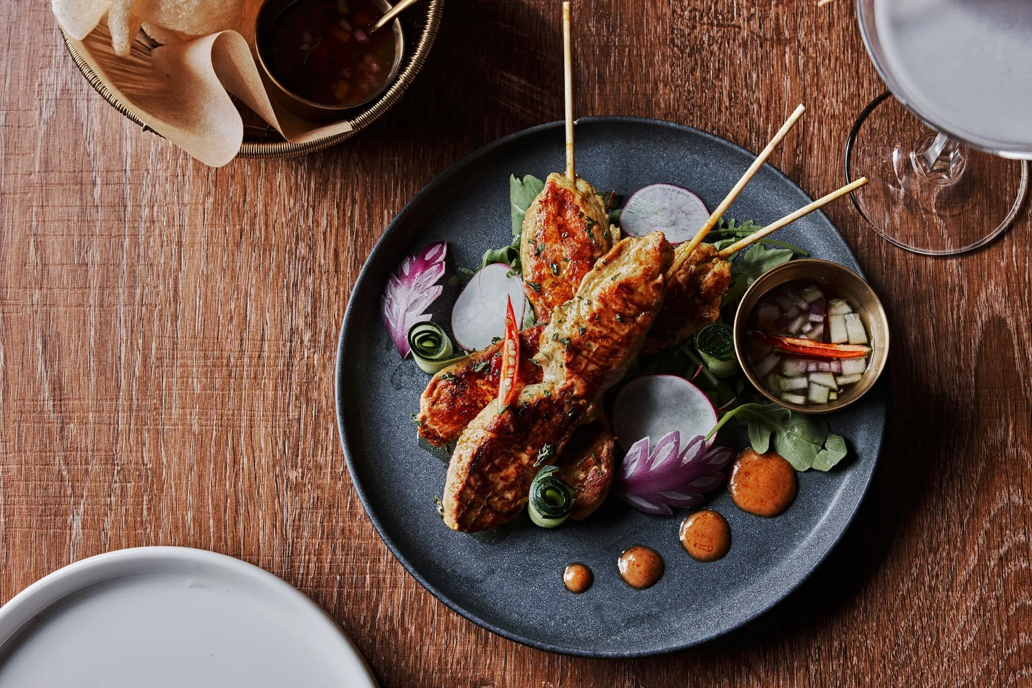 Snap Thai plated fish with fresh herbs and vegetables